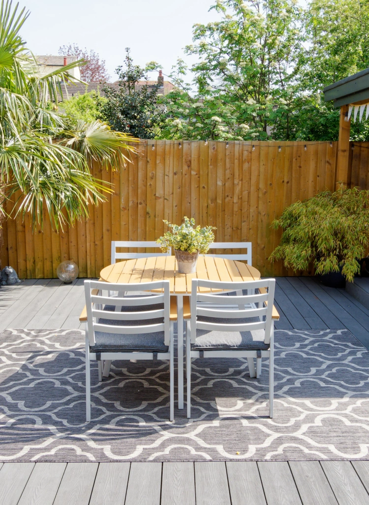Minimalistic English modern garden with table and chairs on patio