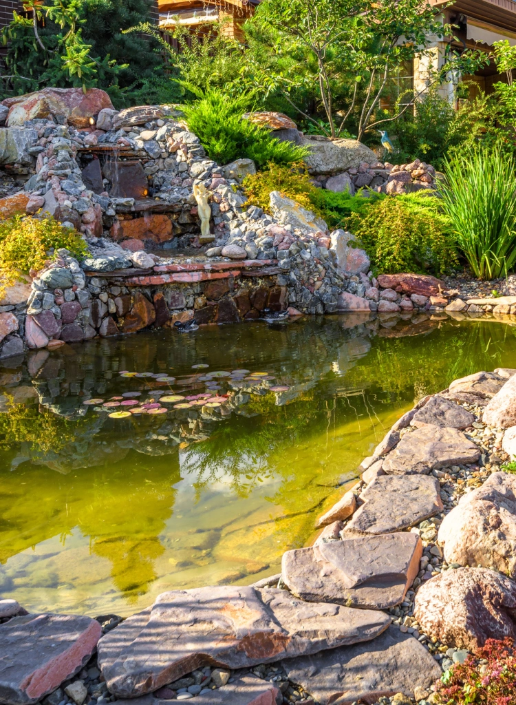 Landscape design of home garden close up Beautiful landscaping with small pond and waterfall