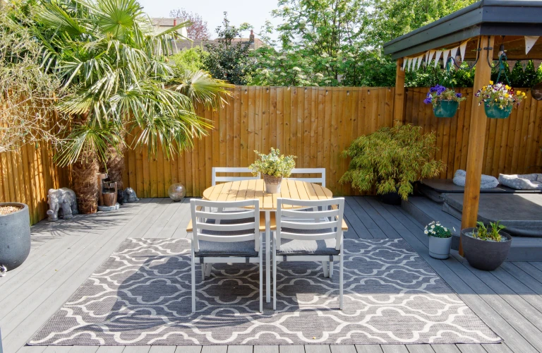 Minimalistic English modern garden with table and chairs on patio